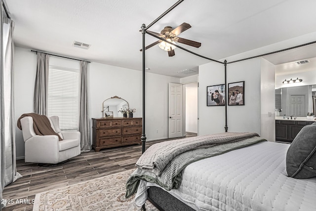 3109 N Black Rock Rd, Buckeye, AZ 85396 - bedroom with wood finished floors, connected bathroom, and ceiling fan