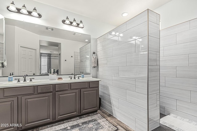 3109 N Black Rock Rd, Buckeye, AZ 85396 - bathroom featuring double vanity, walk in shower, recessed lighting, and wood finished floors