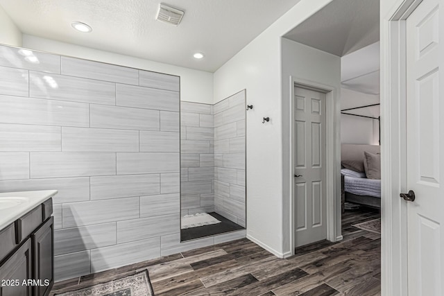 3109 N Black Rock Rd, Buckeye, AZ 85396 - bathroom featuring a walk in shower, wood finished floors, vanity, ensuite bathroom, and recessed lighting