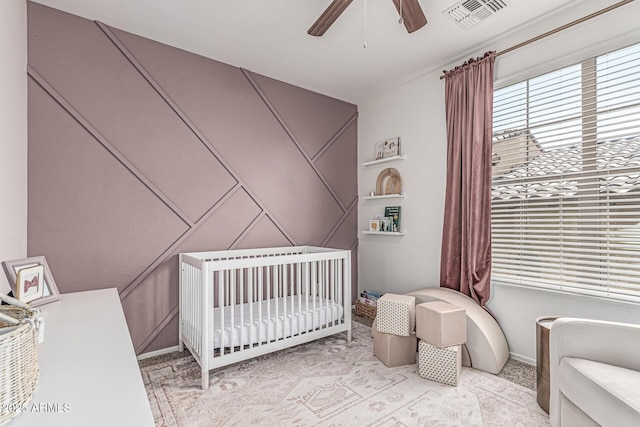 3109 N Black Rock Rd, Buckeye, AZ 85396 - carpeted bedroom with a nursery area, a decorative wall, and a ceiling fan