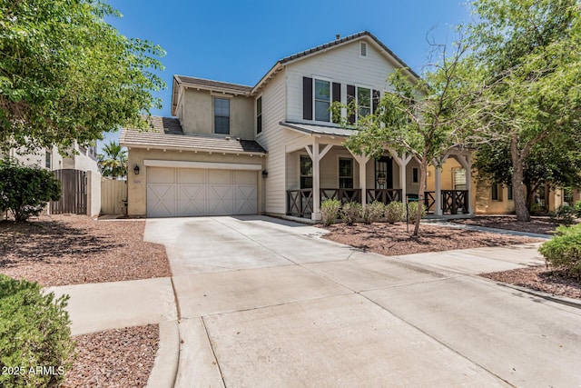 3109 N Black Rock Rd, Buckeye, AZ 85396 - traditional-style house with covered porch, an attached garage, driveway, a tile roof, and stucco siding