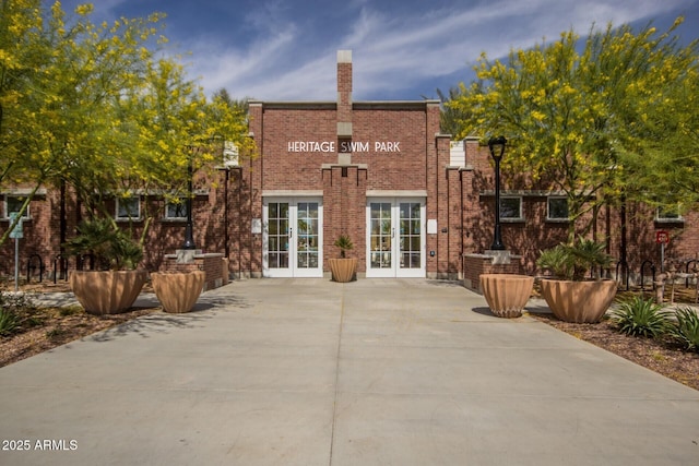3109 N Black Rock Rd, Buckeye, AZ 85396 - rear view of property with french doors, brick siding, and a chimney