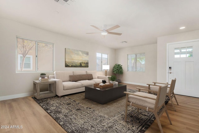 living room with ceiling fan and light hardwood / wood-style floors