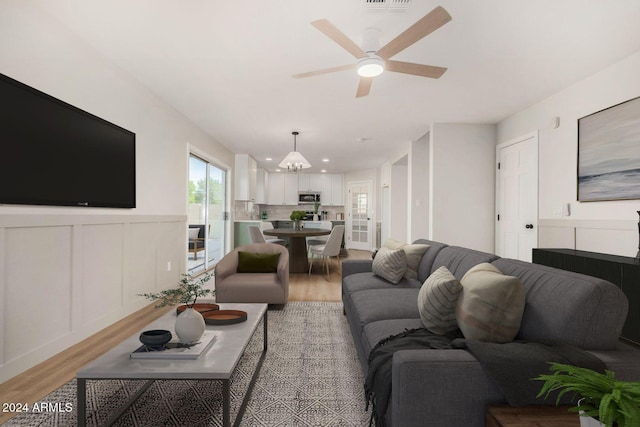 living room with ceiling fan and wood-type flooring