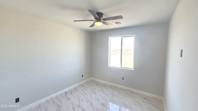 5536 N 375th Ave, Tonopah, AZ 85354 - unfurnished room with light marble finish flooring, ceiling fan, and baseboards