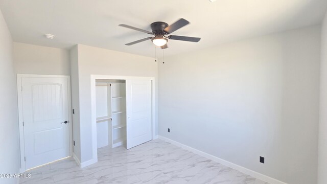 5536 N 375th Ave, Tonopah, AZ 85354 - unfurnished bedroom with light marble finish floors, a closet, and baseboards