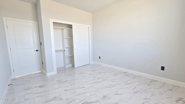 5536 N 375th Ave, Tonopah, AZ 85354 - unfurnished bedroom with baseboards, light marble finish floors, and a closet