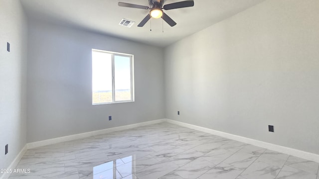 5536 N 375th Ave, Tonopah, AZ 85354 - spare room featuring light marble finish flooring, baseboards, and a ceiling fan