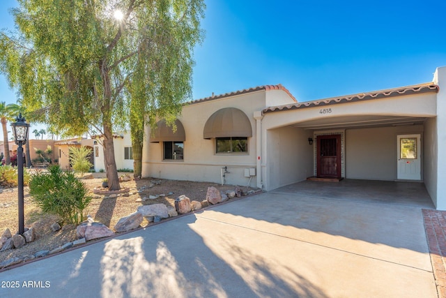 mediterranean / spanish home with a carport