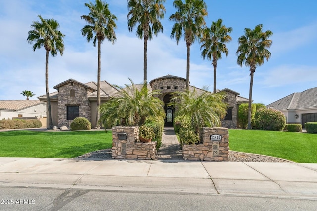 exterior space with a front yard, stone siding, and a tile roof