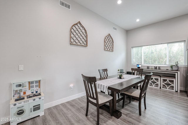 dining space with recessed lighting, visible vents, baseboards, and wood finished floors