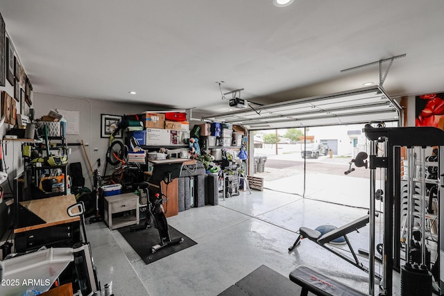 garage with a workshop area, recessed lighting, and a garage door opener