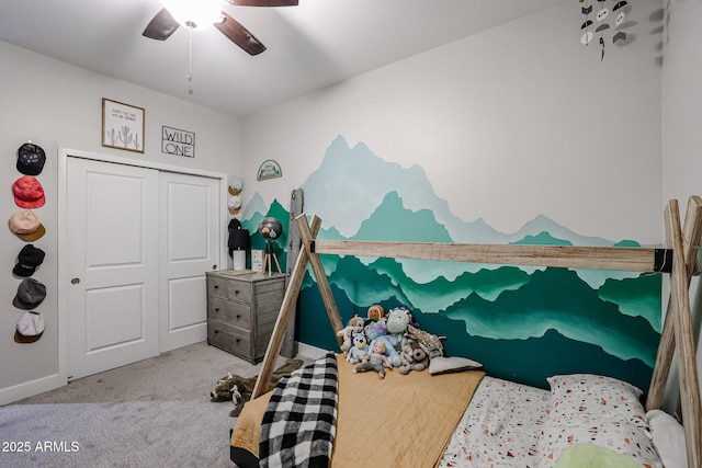 carpeted bedroom with a ceiling fan, a closet, and baseboards