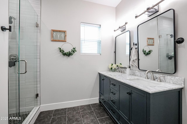 bathroom featuring a shower stall, baseboards, and a sink