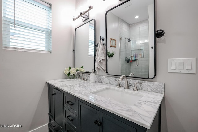 bathroom with double vanity, a sink, and a shower stall