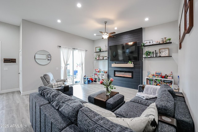 living room with a large fireplace, baseboards, ceiling fan, wood finished floors, and recessed lighting