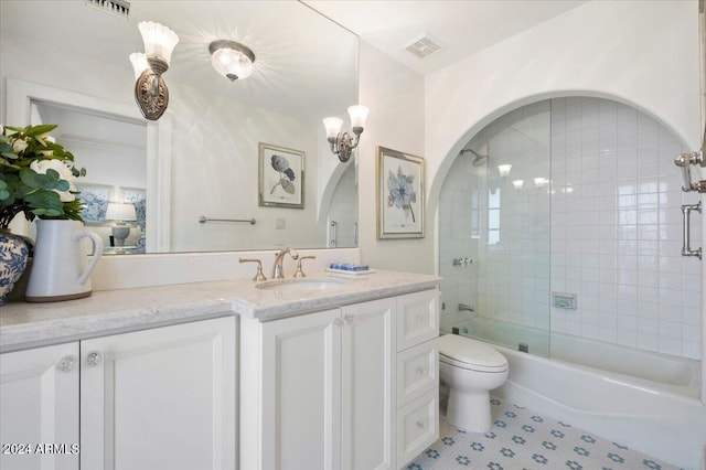 full bathroom with tile patterned flooring, combined bath / shower with glass door, vanity, and toilet