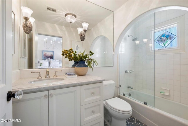 full bathroom featuring tiled shower / bath combo, vanity, and toilet