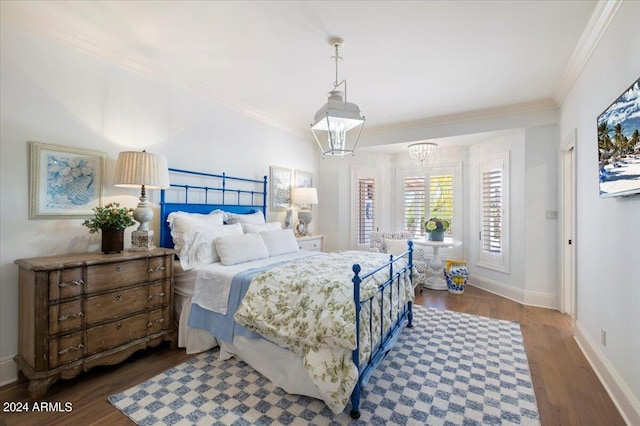 bedroom featuring an inviting chandelier, ornamental molding, and dark hardwood / wood-style flooring