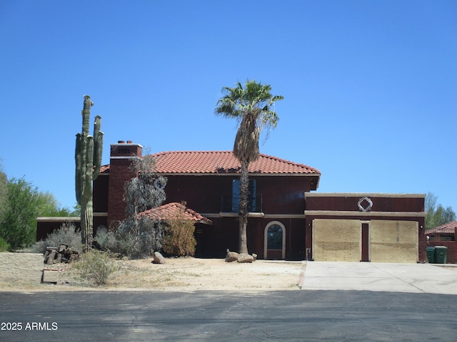 5716 E Desert Vista Trl, Cave Creek, AZ 85331 - view of front facade featuring a chimney, driveway, a tile roof, stucco siding, and an attached garage