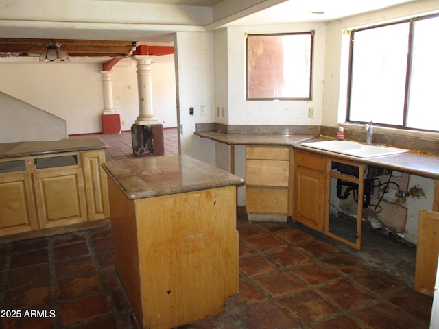 5716 E Desert Vista Trl, Cave Creek, AZ 85331 - kitchen featuring a sink, decorative columns, light brown cabinetry, and a center island