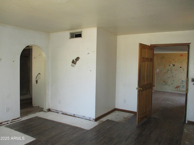 5716 E Desert Vista Trl, Cave Creek, AZ 85331 - spare room with arched walkways, wood finished floors, and baseboards