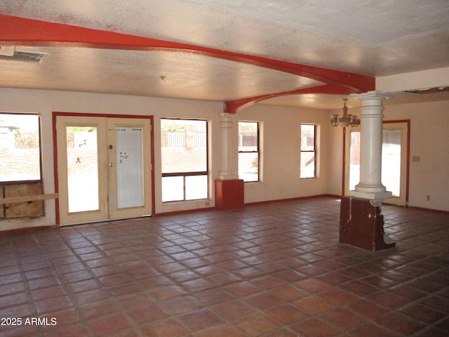5716 E Desert Vista Trl, Cave Creek, AZ 85331 - unfurnished living room featuring decorative columns, baseboards, and tile patterned floors