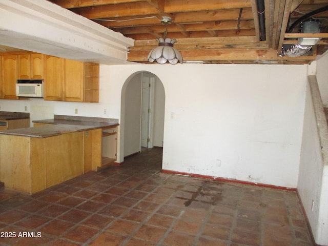 5716 E Desert Vista Trl, Cave Creek, AZ 85331 - kitchen featuring white microwave, arched walkways, and baseboards