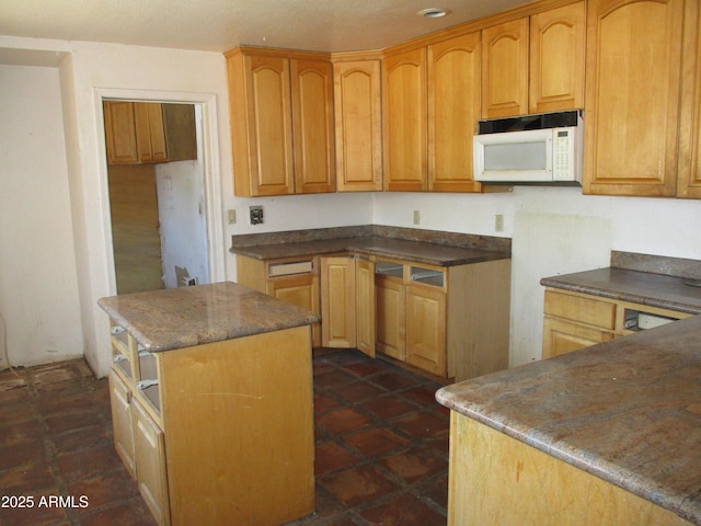 5716 E Desert Vista Trl, Cave Creek, AZ 85331 - kitchen with white microwave, a kitchen island, and dark stone countertops