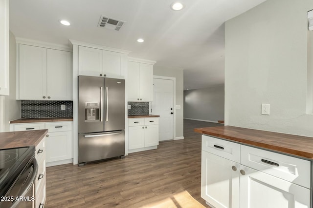 kitchen featuring wooden counters, white cabinetry, and stainless steel appliances