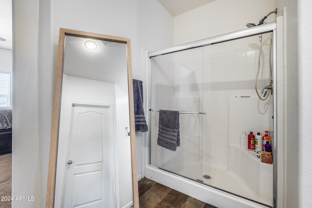 bathroom featuring an enclosed shower and hardwood / wood-style floors