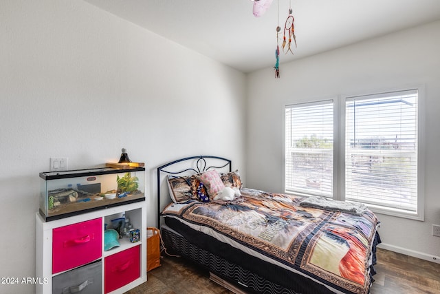 bedroom with dark hardwood / wood-style flooring