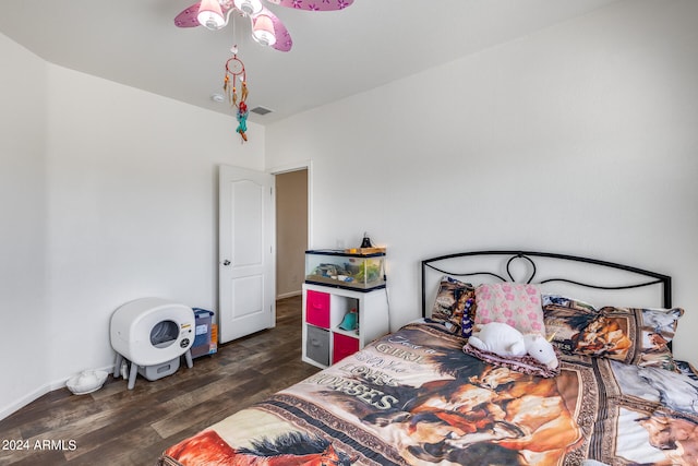 bedroom with dark hardwood / wood-style floors and ceiling fan