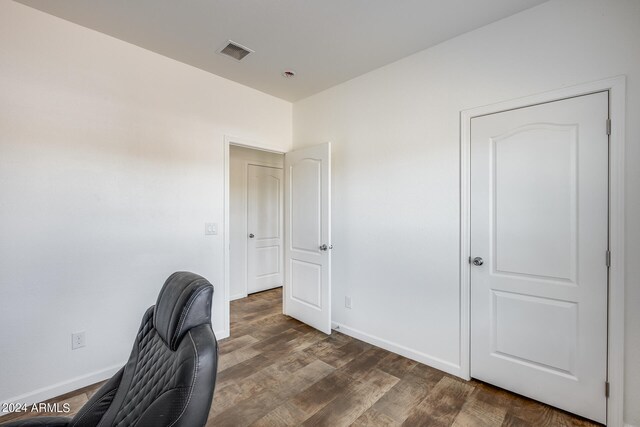 home office with dark hardwood / wood-style floors