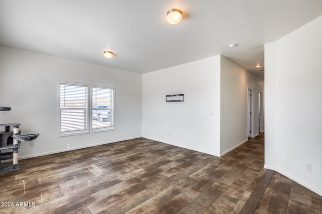 unfurnished living room featuring dark hardwood / wood-style floors