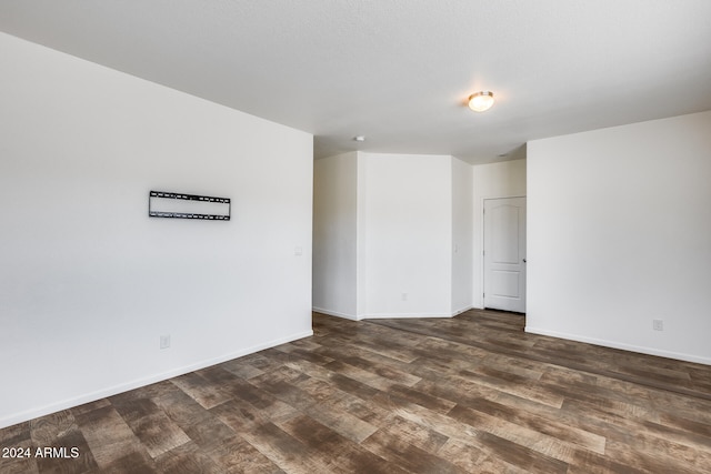 unfurnished room featuring dark wood-type flooring