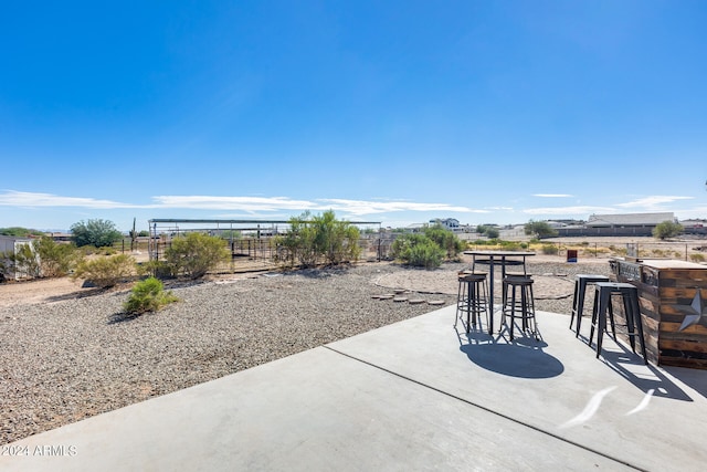 view of patio / terrace featuring a mountain view and a bar