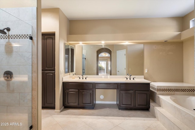 bathroom featuring tile patterned flooring, vanity, and plus walk in shower