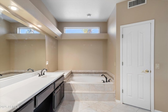 bathroom with vanity and tiled bath