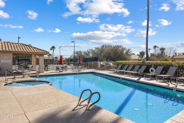 view of pool featuring a hot tub and a patio