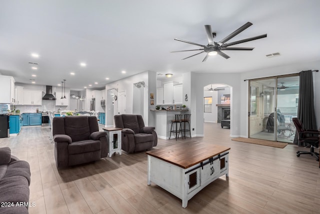 living room featuring ceiling fan and light wood-type flooring