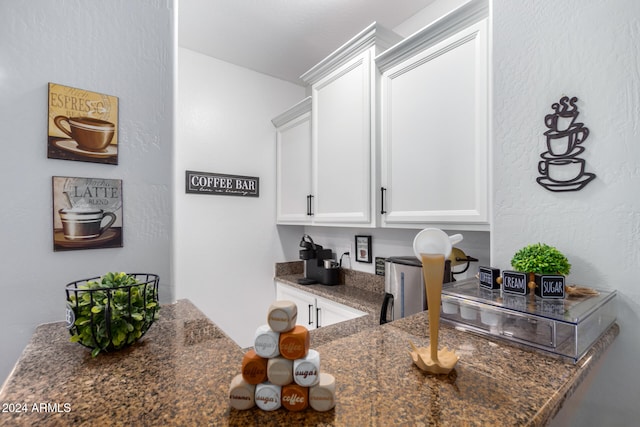 kitchen with white cabinets and dark stone countertops