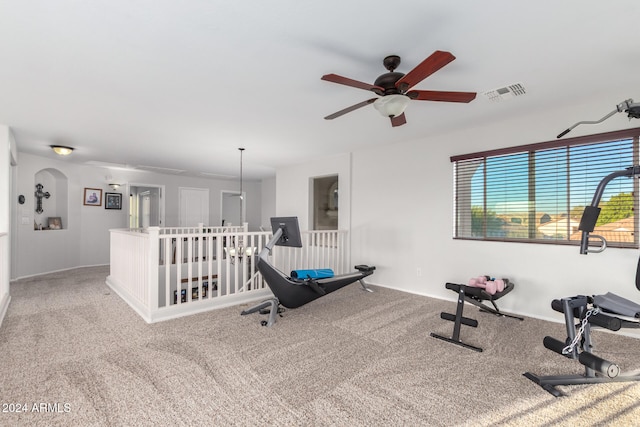 exercise area featuring ceiling fan and carpet floors