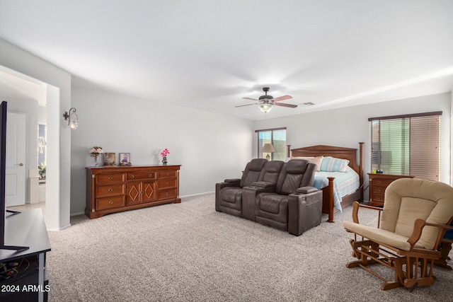 bedroom with ceiling fan and light carpet