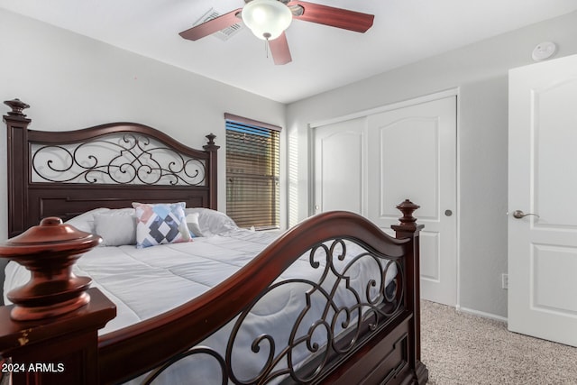 bedroom featuring light carpet, a closet, and ceiling fan