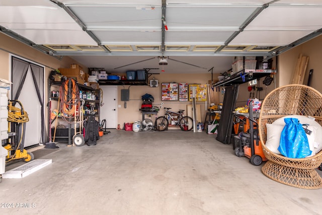 garage with electric panel and a garage door opener