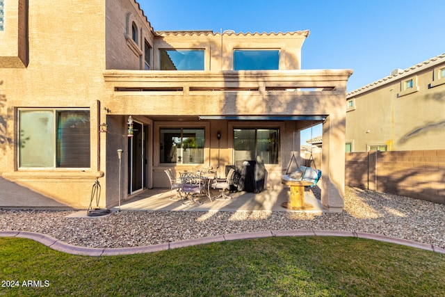 rear view of property featuring a patio area