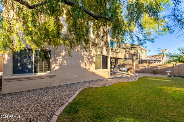 back of property featuring a yard and a patio area