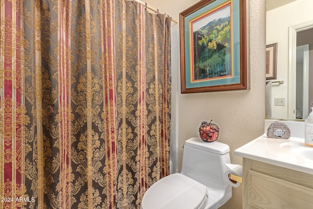 bathroom featuring vanity, toilet, and walk in shower