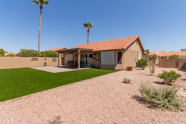 back of property featuring a patio area and a yard